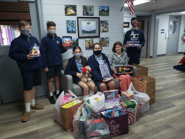 Beta Club holding toys for tots